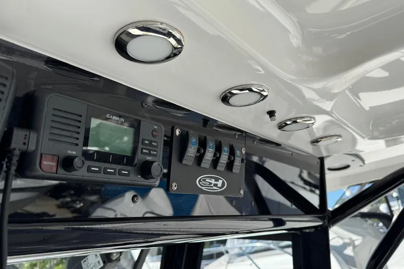 Slide: The Image of 2022 Sea Hunt Gamefish 27 dashboard with Garmin radio and control panel. - 20