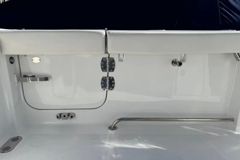 Slide: The Image of 2022 Sea Hunt Gamefish 27 Forward Seating boat interior with white upholstery and stainless steel fittings. - 21