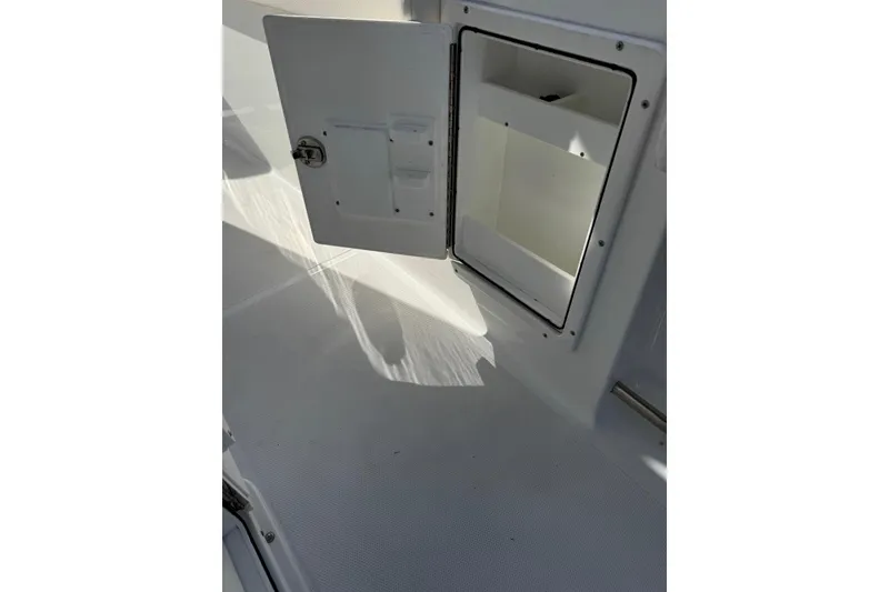 Slide: The Image of Open storage compartment on 2022 Sea Hunt Gamefish 27 Forward Seating boat. - 27