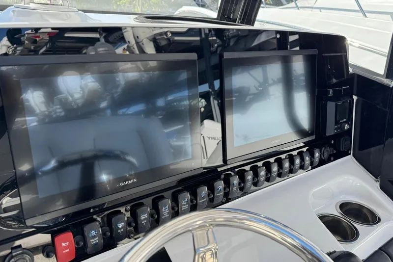 Slide: The Image of 2022 Sea Hunt Gamefish 27 dashboard with dual Garmin displays and control panel. - 4