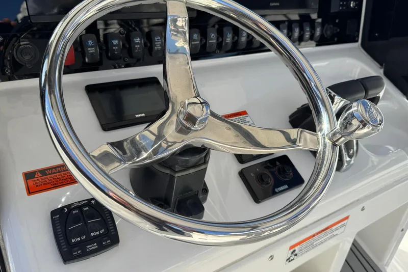 Slide: The Image of Steering wheel and controls of 2022 Sea Hunt Gamefish 27 Forward Seating boat. - 6