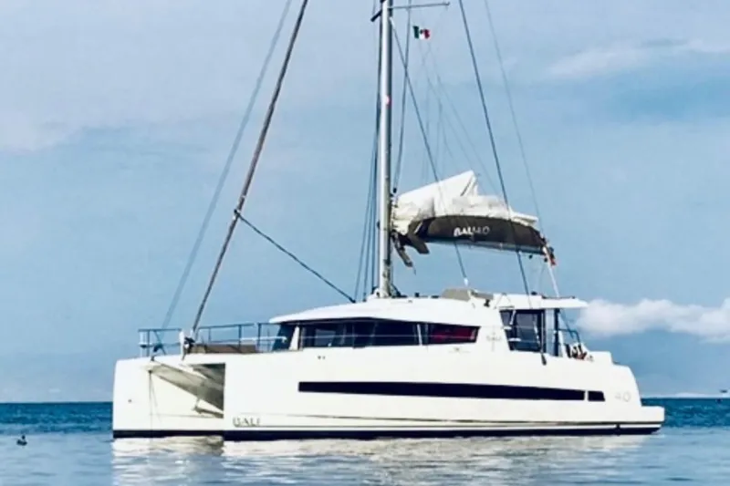 Slide: The Image of 2017 Bali 4.0 catamaran sailing on calm waters under a clear sky. - 0
