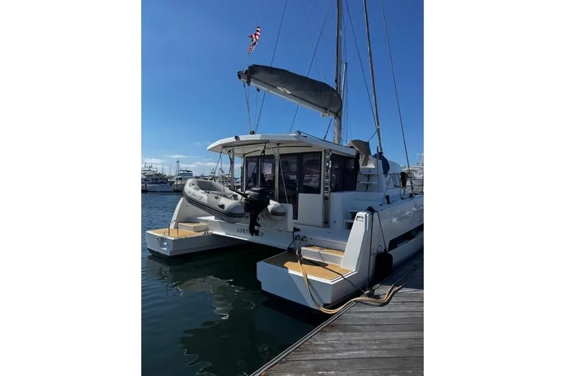 Slide: The Image of 2017 Bali 4.0 catamaran docked at marina with inflatable boat on deck. - 3