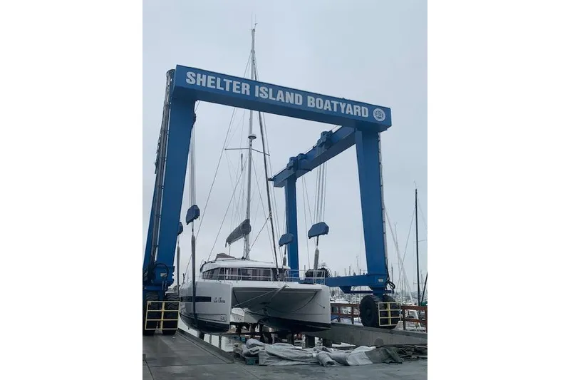Slide: The Image of Bali 4.0 catamaran at Shelter Island Boatyard, 2017 model, in a boat lift. - 6
