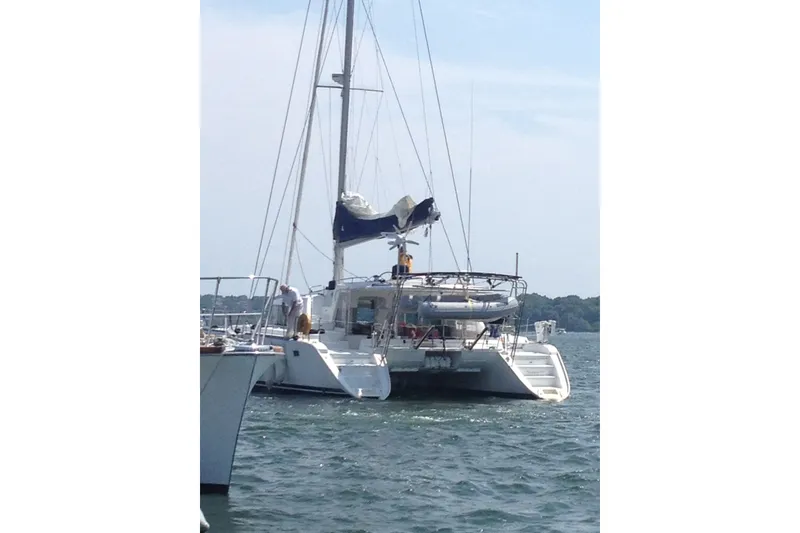 Slide: The Image of 2008 Lagoon 440 catamaran anchored on a sunny day, rear view. - 27