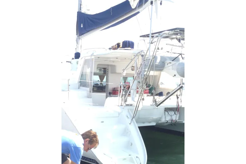 Slide: The Image of 2008 Lagoon 440 catamaran with blue sail cover, docked at marina. - 30