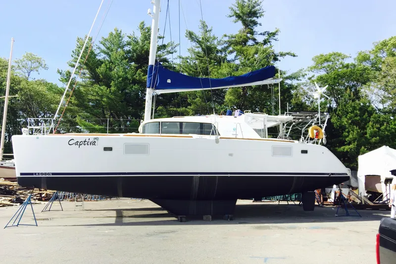 Slide: The Image of 2008 Lagoon 440 catamaran named Captiva on land, surrounded by trees. - 34