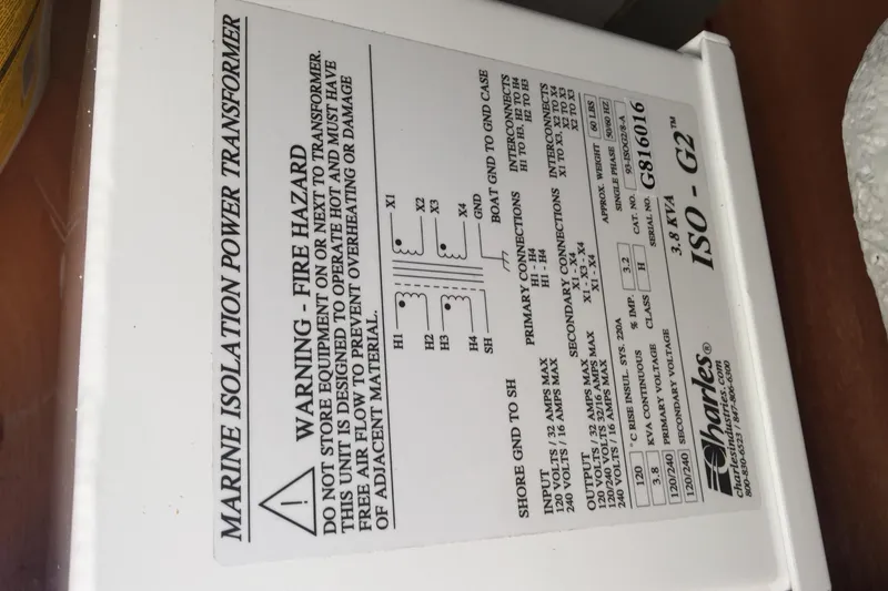 Slide: The Image of Marine isolation power transformer label on Lagoon 440, 2008 model, with safety warnings and specifications. - 37