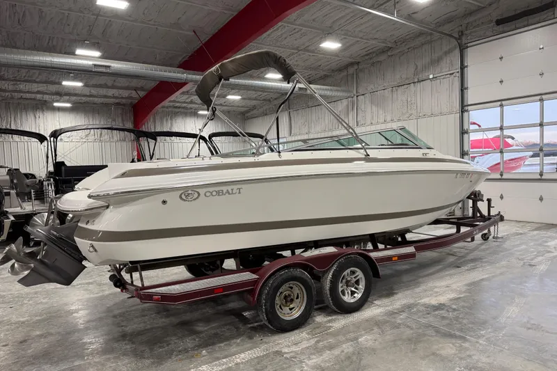 Slide: The Image of 2000 Cobalt 246 boat on trailer in indoor storage facility. - 3