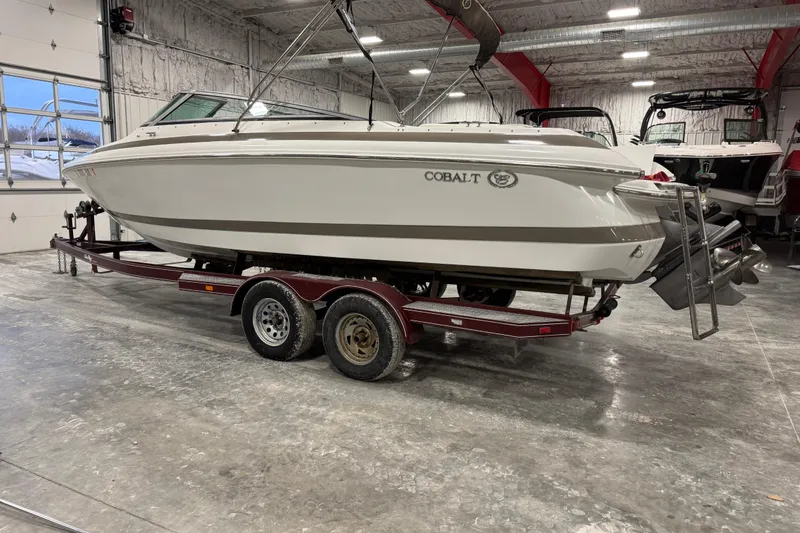 Slide: The Image of 2000 Cobalt 246 boat on trailer in indoor storage facility. - 6