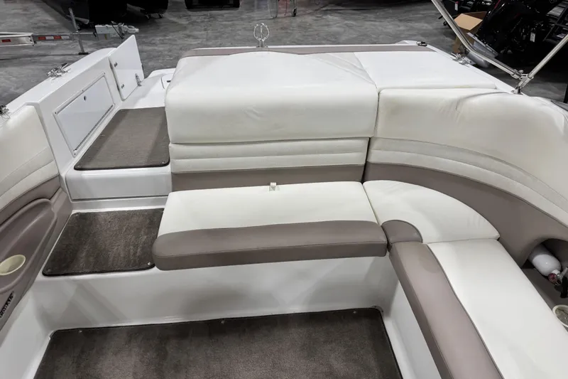 Slide: The Image of 2000 Cobalt 246 boat interior with white and beige seating, carpeted flooring. - 8