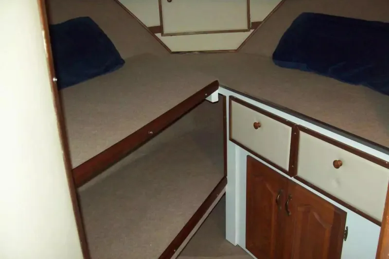 Slide: The Image of 1979 Chris-Craft 350 Catalina cabin interior with bunk beds and storage cabinets. - 7