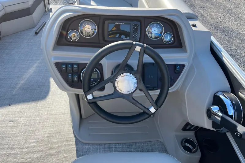 Slide: The Image of 2023 Berkshire 24RFX LE boat dashboard with steering wheel and control panel. - 10