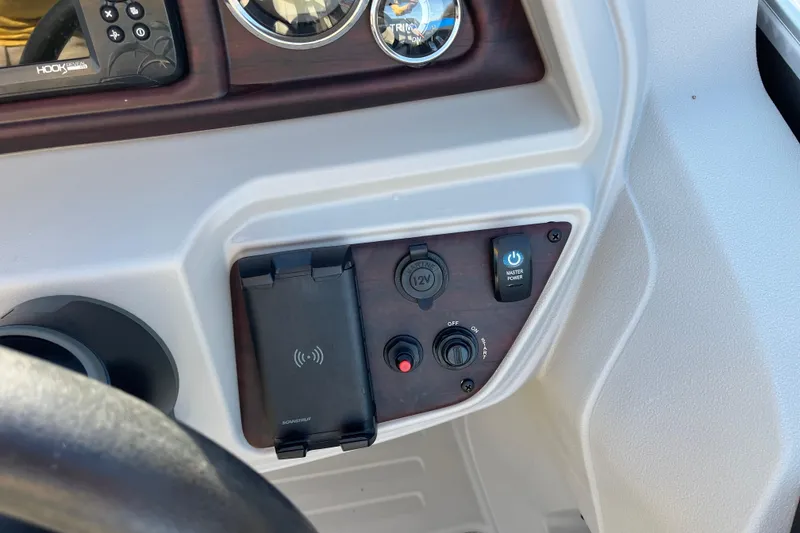 Slide: The Image of 2023 Berkshire 24RFX LE dashboard with controls and wireless charging pad. - 13