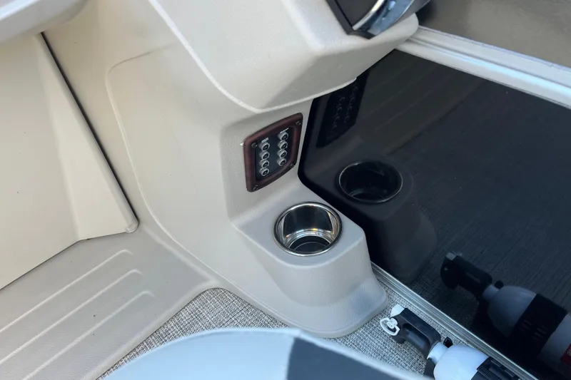 Slide: The Image of Interior of 2023 Berkshire 24RFX LE boat with cup holder and control panel. - 15