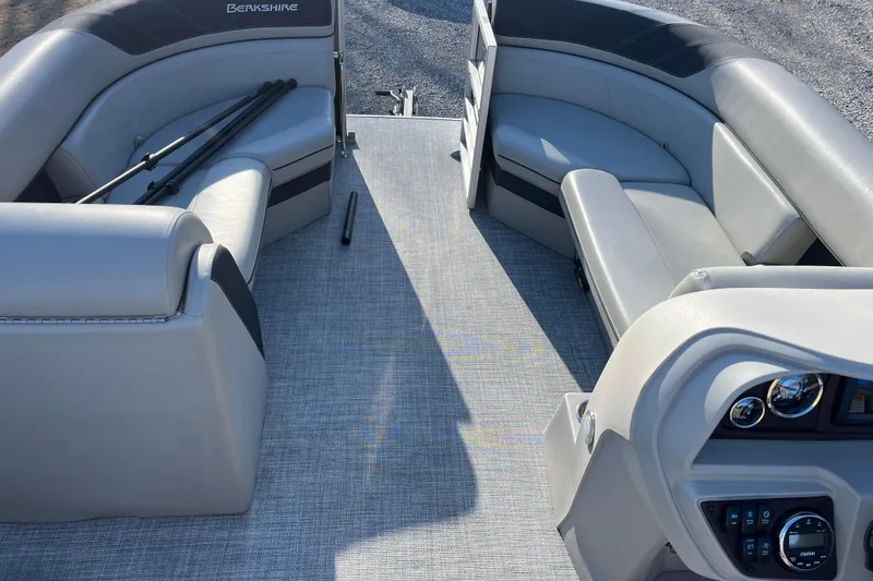 Slide: The Image of 2023 Berkshire 24RFX LE pontoon boat interior with gray seating and control panel. - 6