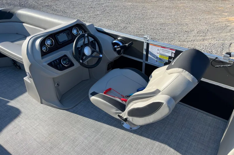 Slide: The Image of 2023 Berkshire 24RFX LE boat interior with steering wheel and captain's chair. - 9