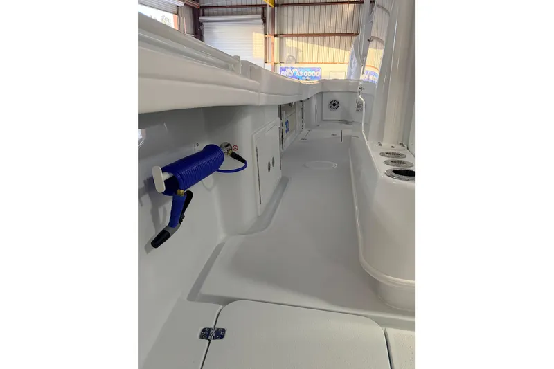 Slide: The Image of 2026 Yellowfin 32 Offshore boat interior with hose and storage compartments. - 12