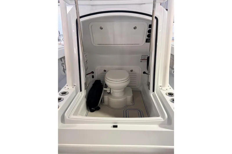 Slide: The Image of 2026 Yellowfin 32 Offshore boat interior with a compact marine toilet. - 13