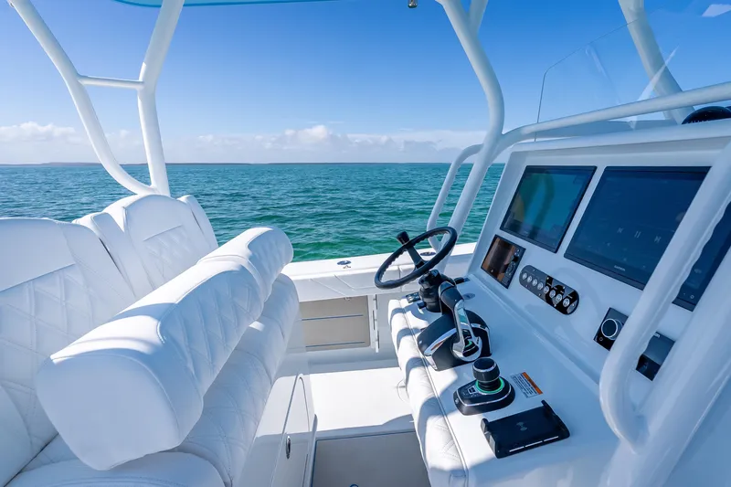Slide: The Image of 2026 Yellowfin 32 Offshore boat interior with modern controls and ocean view. - 19