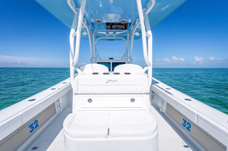 Slide: The Image of 2026 Yellowfin 32 Offshore boat on open sea, showcasing sleek design and spacious deck. - 24