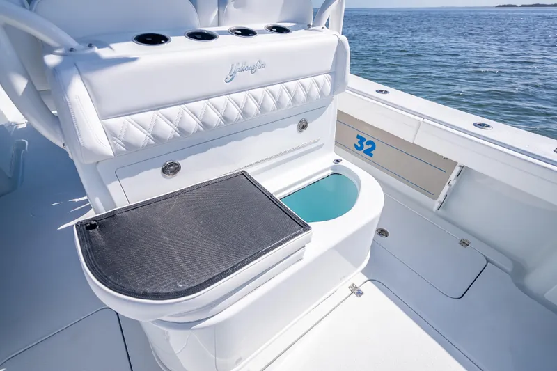 Slide: The Image of 2026 Yellowfin 32 Offshore boat interior with seating and storage, ocean view. - 29
