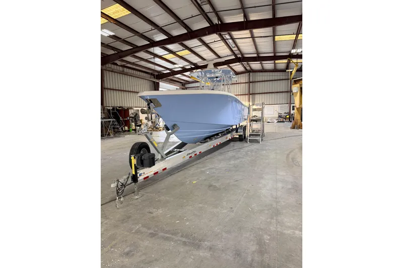 Slide: The Image of 2026 Yellowfin 32 Offshore boat in a warehouse on a trailer. - 3