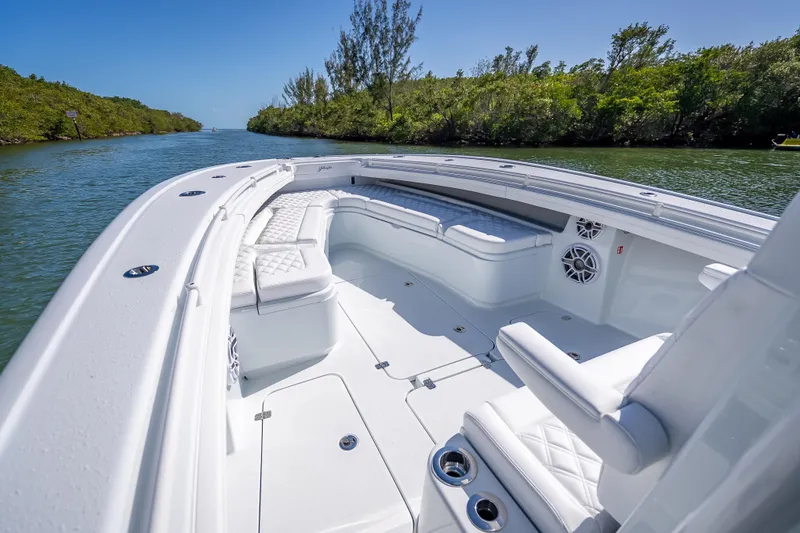 Slide: The Image of 2026 Yellowfin 32 Offshore boat with luxurious seating on a scenic waterway. - 30