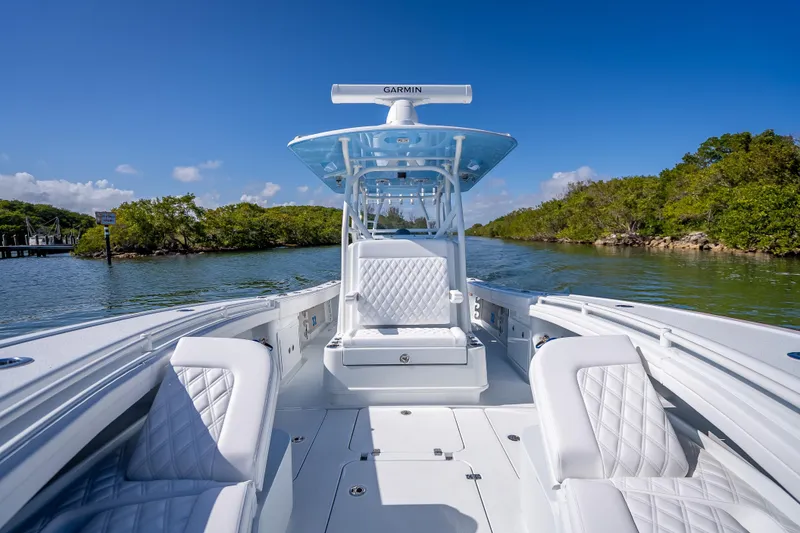 Slide: The Image of 2026 Yellowfin 32 Offshore boat with luxurious seating on a serene waterway. - 31