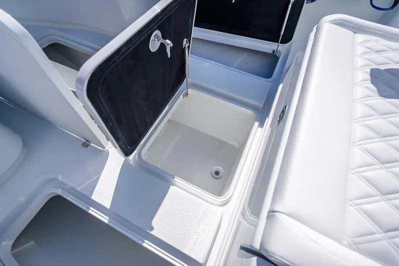 Slide: The Image of 2026 Yellowfin 32 Offshore boat storage compartments and seating detail. - 36