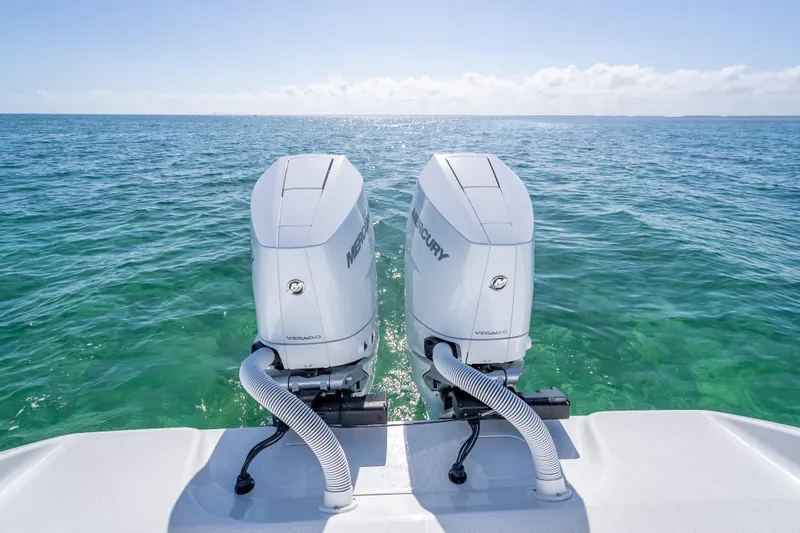 Slide: The Image of Twin Mercury outboard engines on a 2026 Yellowfin 32 Offshore boat in clear ocean waters. - 39