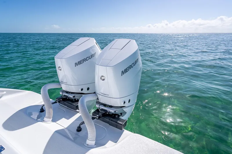 Slide: The Image of Twin Mercury outboard engines on a 2026 Yellowfin 32 Offshore boat in clear ocean waters. - 40