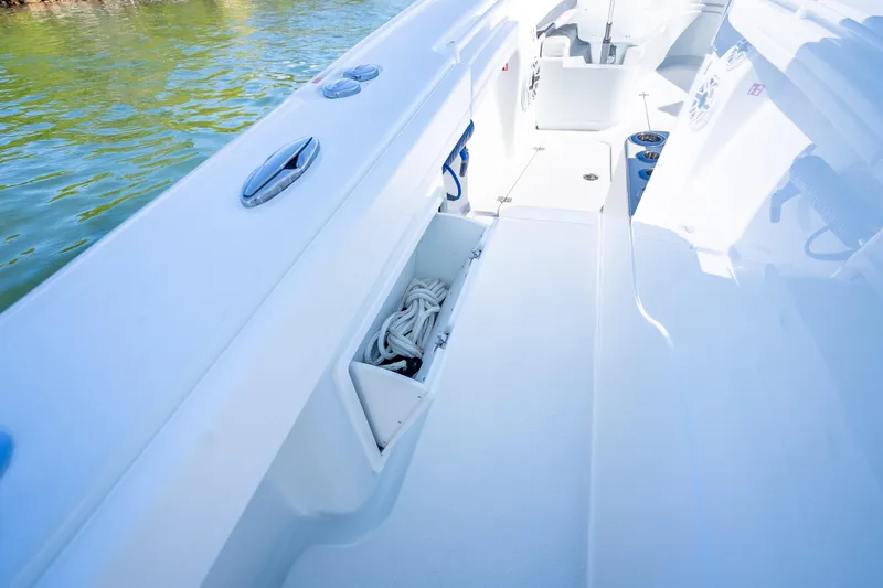 Slide: The Image of 2026 Yellowfin 32 Offshore boat interior with storage compartment and coiled rope. - 41