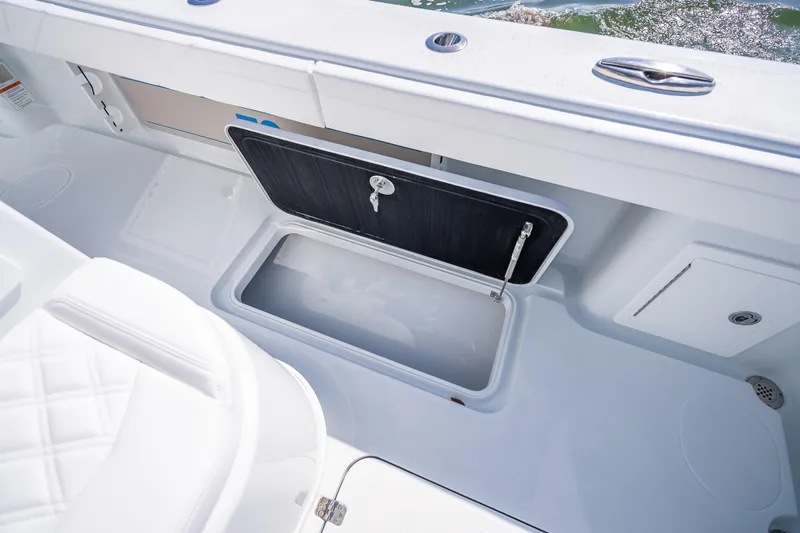Slide: The Image of 2026 Yellowfin 32 Offshore boat with open storage compartment on deck. - 42