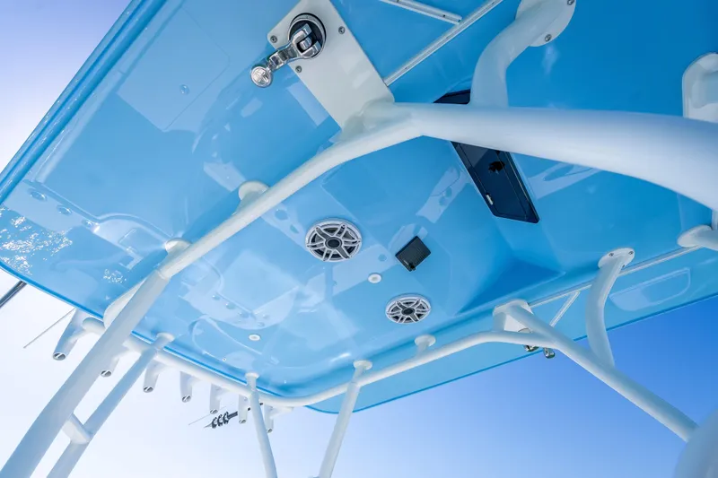 Slide: The Image of 2026 Yellowfin 32 Offshore boat's blue T-top with speakers and rod holders. - 46