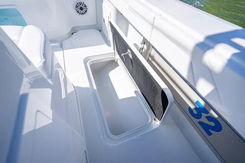 Slide: The Image of 2026 Yellowfin 32 Offshore boat interior with storage compartment and speaker. - 47