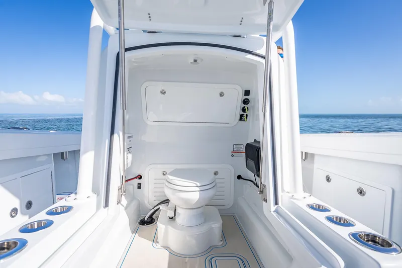 Slide: The Image of 2026 Yellowfin 32 Offshore boat interior with marine toilet, ocean view. - 49