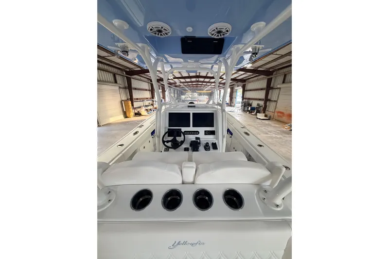 Slide: The Image of 2026 Yellowfin 32 Offshore boat interior with helm, steering wheel, and navigation screens. - 5