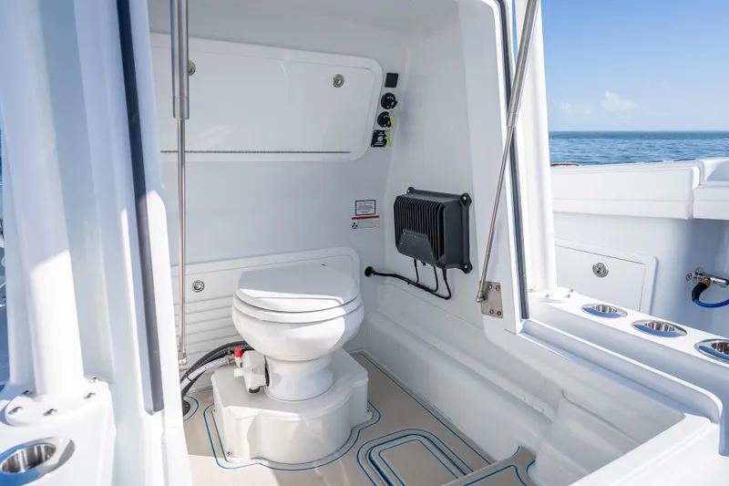 Slide: The Image of 2026 Yellowfin 32 Offshore boat interior with modern marine toilet and ocean view. - 50