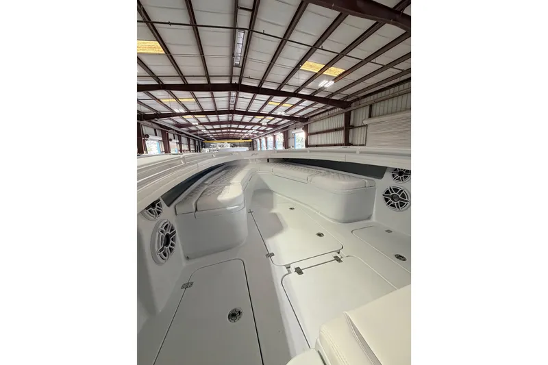 Slide: The Image of 2026 Yellowfin 32 Offshore boat interior with white seating and storage compartments. - 6