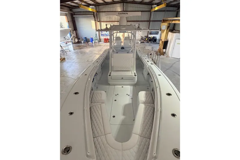 Slide: The Image of 2026 Yellowfin 32 Offshore boat interior in a workshop setting. - 9