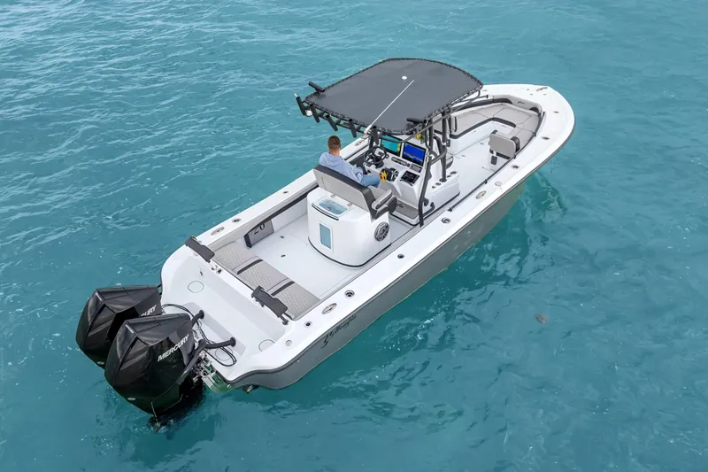 Slide: The Image of 2024 Yellowfin 26 Hybrid boat on clear blue water, featuring dual outboard engines. - 11