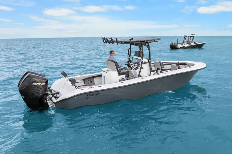 Slide: The Image of 2024 Yellowfin 26 Hybrid boat on clear blue ocean water. - 12