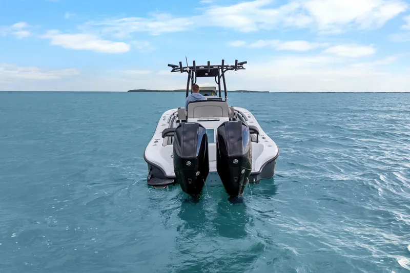 Slide: The Image of 2024 Yellowfin 26 Hybrid boat on open water, featuring dual outboard engines. - 13