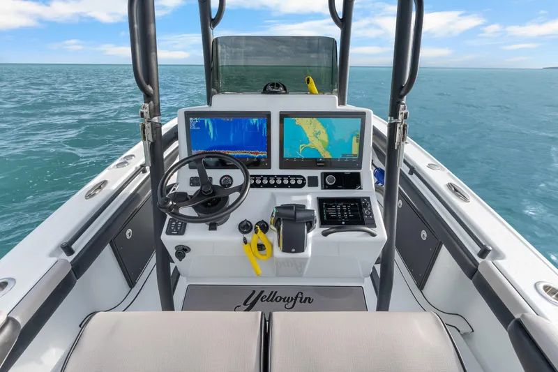 Slide: The Image of 2024 Yellowfin 26 Hybrid boat dashboard with navigation screens on open water. - 20