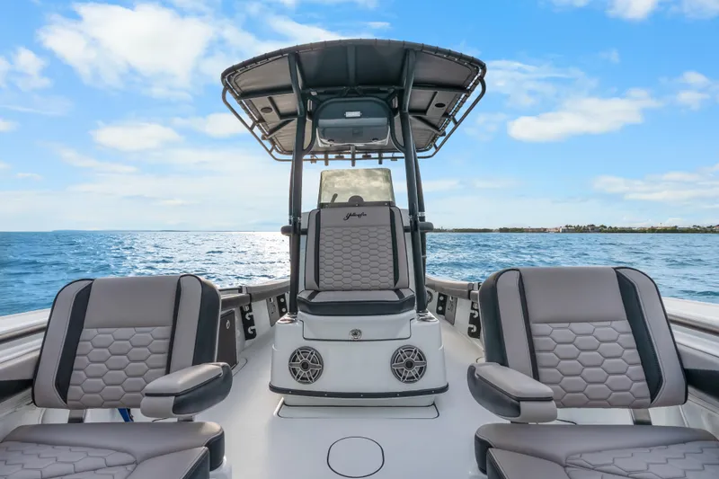 Slide: The Image of 2024 Yellowfin 26 Hybrid boat interior with cushioned seating on open water. - 26