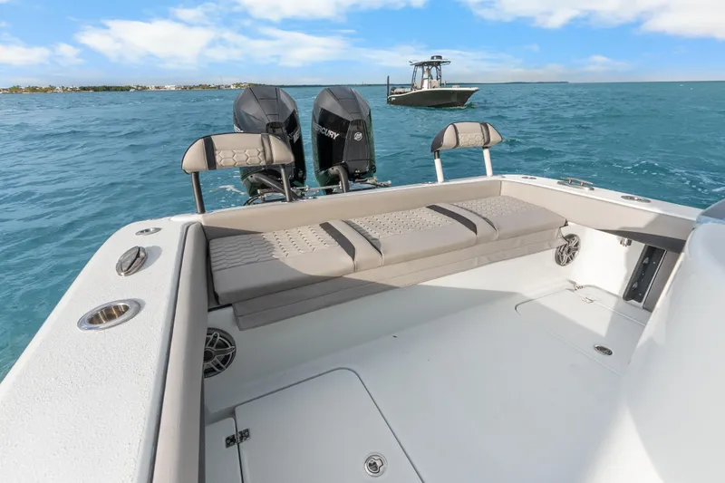 Slide: The Image of 2024 Yellowfin 26 Hybrid boat with dual Mercury engines on open water. - 27