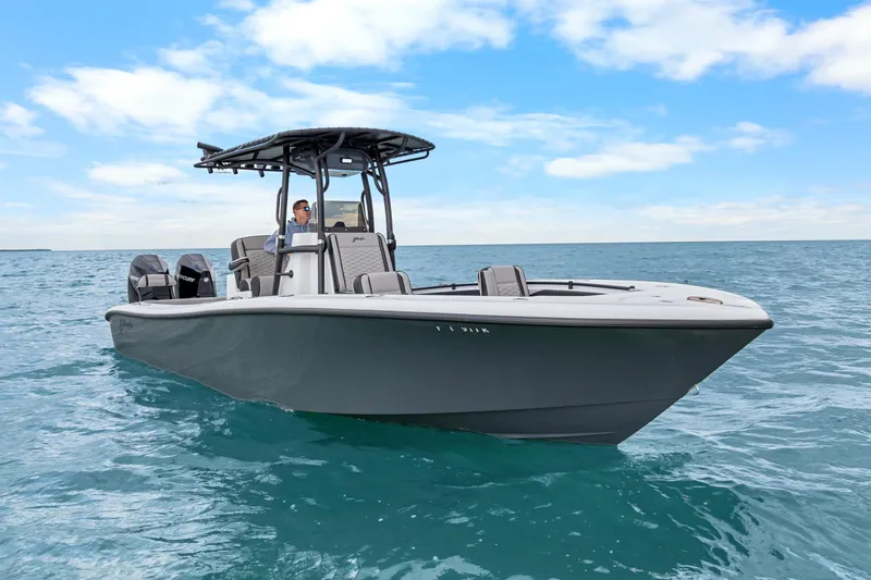 Slide: The Image of 2024 Yellowfin 26 Hybrid boat cruising on open water under a clear blue sky. - 7