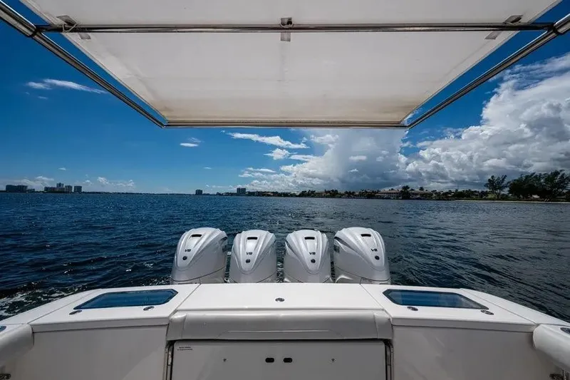 Slide: The Image of 2019 Everglades 435 Center Console boat with four engines on open water. - 10