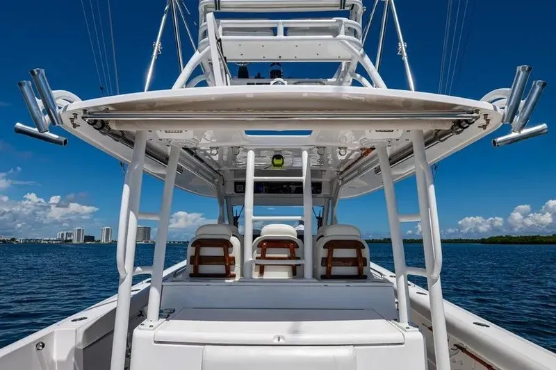Slide: The Image of 2019 Everglades 435 Center Console boat on water, clear sky background. - 13